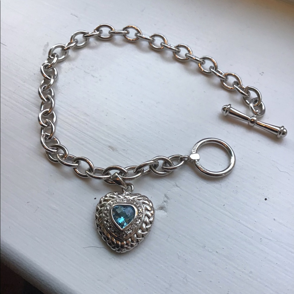 Silver bracelet with blue stone heart charm